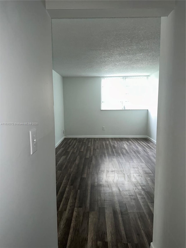8897 Fontainebleau Blvd Unit 208, Miami, FL 33172 - unfurnished room with dark wood-type flooring and a textured ceiling