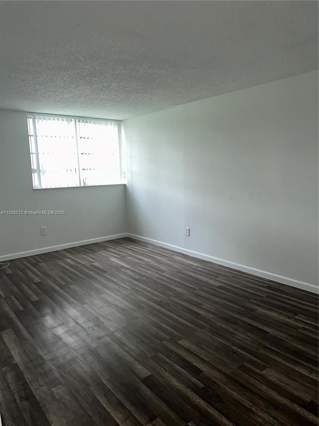 8897 Fontainebleau Blvd Unit 208, Miami, FL 33172 - unfurnished room featuring dark wood finished floors and a textured ceiling