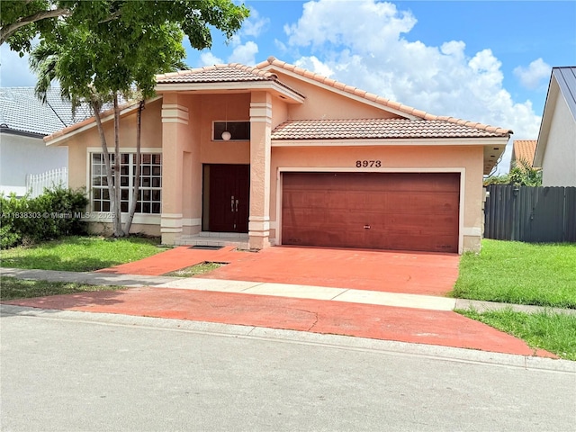 8973 NW 147th Ter, Miami Lakes, FL 33018 - mediterranean / spanish home with stucco siding, a garage, a tiled roof, and concrete driveway