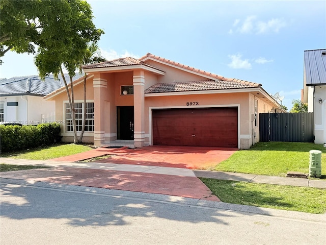 8973 NW 147th Ter, Miami Lakes, FL 33018 - mediterranean / spanish-style house with an attached garage, stucco siding, decorative driveway, and a tiled roof