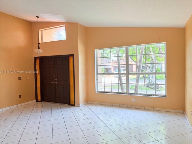 8973 NW 147th Ter, Miami Lakes, FL 33018 - foyer with healthy amount of natural light, tile patterned flooring, and vaulted ceiling