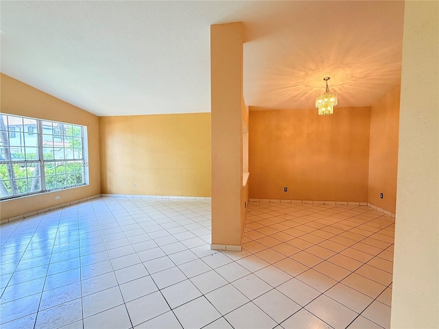 8973 NW 147th Ter, Miami Lakes, FL 33018 - spare room with vaulted ceiling, light tile patterned floors, and a chandelier