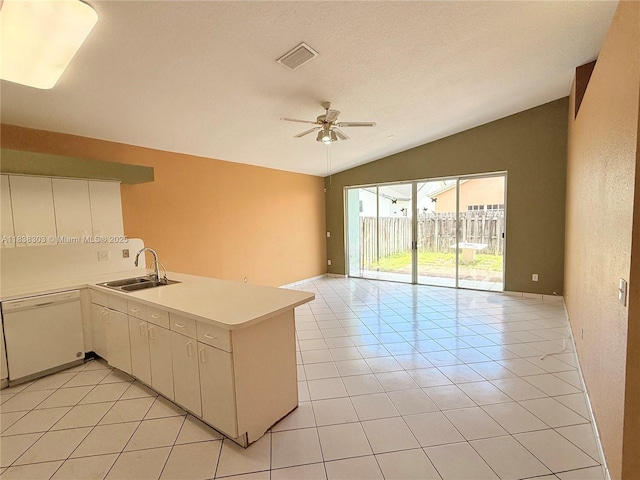 8973 NW 147th Ter, Miami Lakes, FL 33018 - kitchen featuring dishwasher, vaulted ceiling, a peninsula, open floor plan, and light countertops