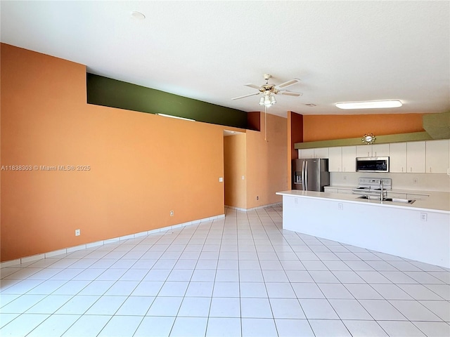 8973 NW 147th Ter, Miami Lakes, FL 33018 - kitchen featuring stainless steel appliances, light countertops, a ceiling fan, white cabinets, and a peninsula