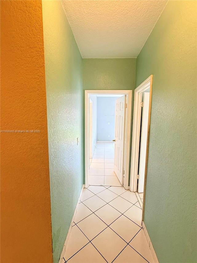 8973 NW 147th Ter, Miami Lakes, FL 33018 - hall with a textured wall, a textured ceiling, and light tile patterned floors