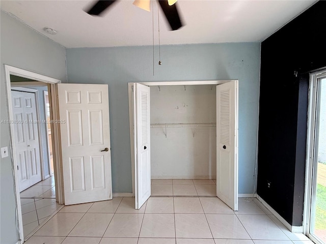 8973 NW 147th Ter, Miami Lakes, FL 33018 - unfurnished bedroom featuring a closet, light tile patterned flooring, and ceiling fan