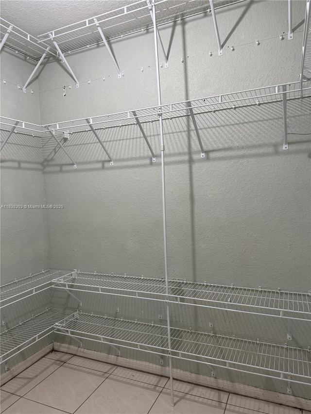 8973 NW 147th Ter, Miami Lakes, FL 33018 - walk in closet with tile patterned floors