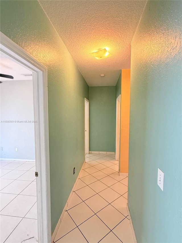8973 NW 147th Ter, Miami Lakes, FL 33018 - hallway featuring light tile patterned floors and a textured ceiling