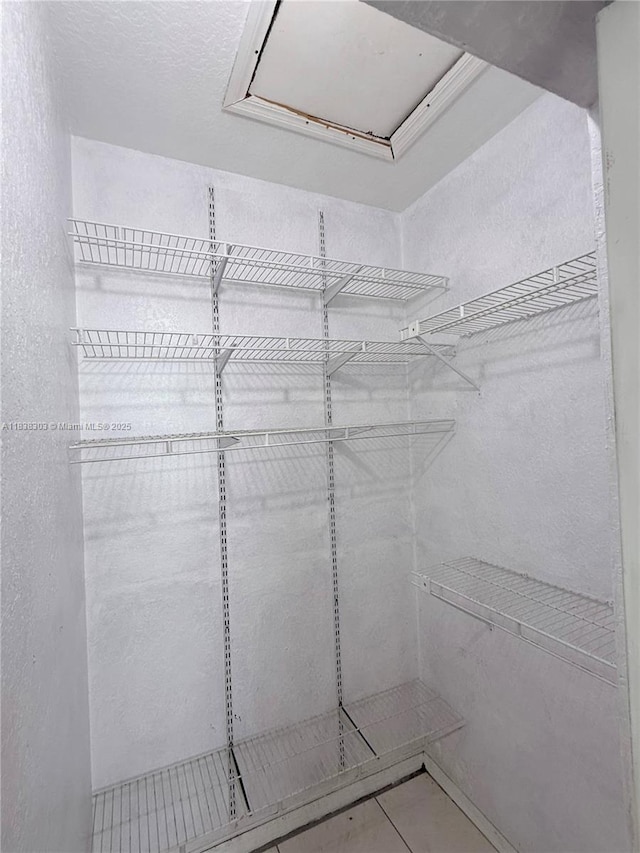 8973 NW 147th Ter, Miami Lakes, FL 33018 - spacious closet featuring tile patterned floors
