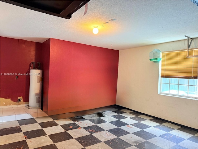 8973 NW 147th Ter, Miami Lakes, FL 33018 - spare room with electric water heater, a textured ceiling, and tile patterned floors