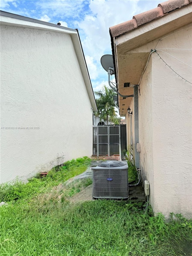 8973 NW 147th Ter, Miami Lakes, FL 33018 - view of home's exterior featuring a central air condition unit and stucco siding