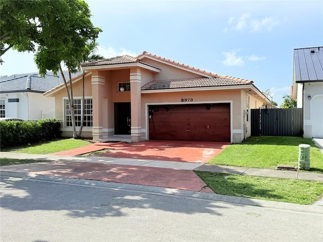 8973 NW 147th Ter, Miami Lakes, FL 33018 - view of front of house featuring stucco siding, an attached garage, driveway, and a tiled roof