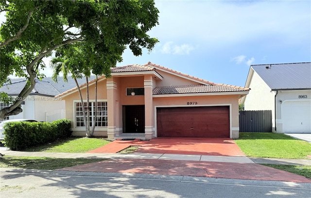 8973 NW 147th Ter, Miami Lakes, FL 33018 - view of front of house featuring a tile roof, stucco siding, concrete driveway, and a garage