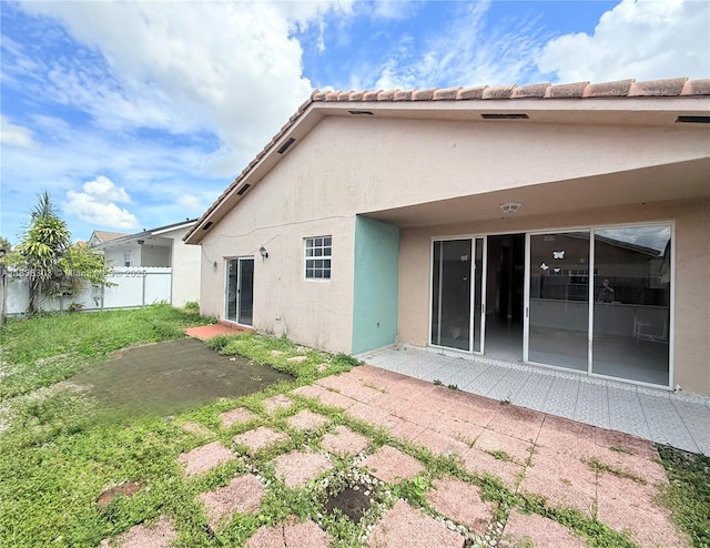 8973 NW 147th Ter, Miami Lakes, FL 33018 - back of property with stucco siding and a patio