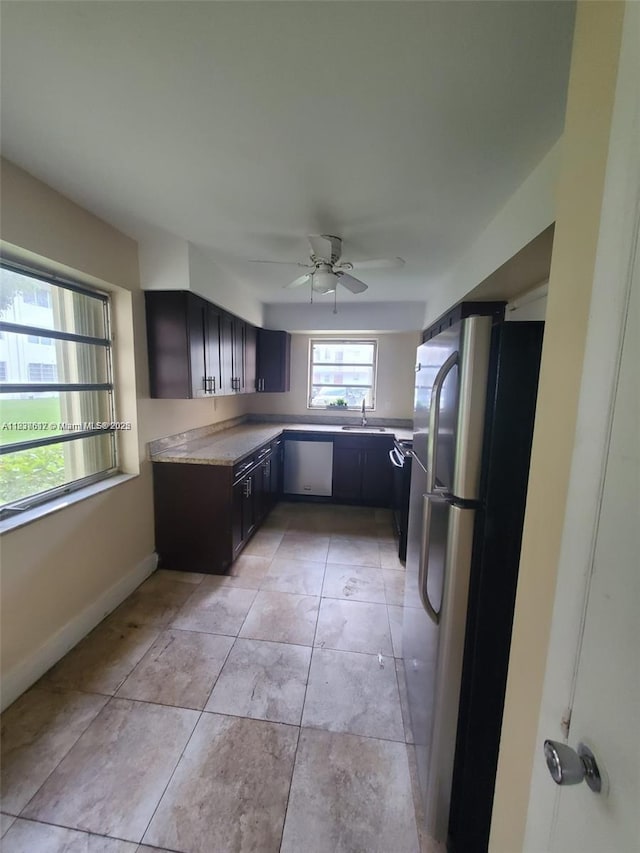 1450 NE 191st St Unit 106, Miami, FL 33179 - kitchen featuring freestanding refrigerator, dishwashing machine, a ceiling fan, light countertops, and light tile patterned floors