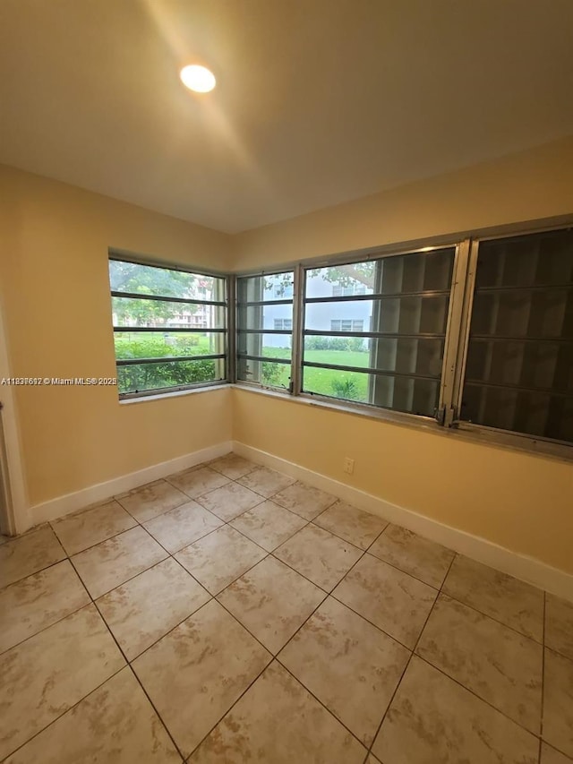 1450 NE 191st St Unit 106, Miami, FL 33179 - unfurnished room with baseboards and light tile patterned flooring