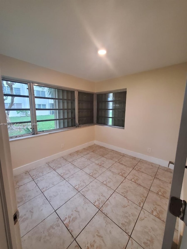 1450 NE 191st St Unit 106, Miami, FL 33179 - empty room featuring light tile patterned flooring and baseboards