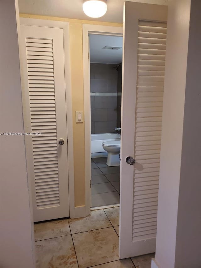 1450 NE 191st St Unit 106, Miami, FL 33179 - hallway with light tile patterned floors