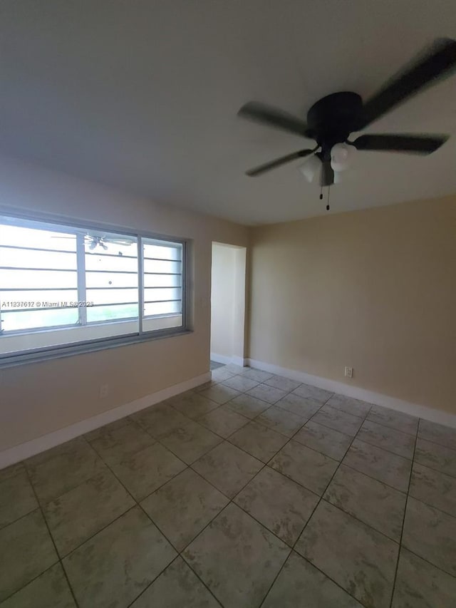 1450 NE 191st St Unit 106, Miami, FL 33179 - empty room with tile patterned flooring and a ceiling fan