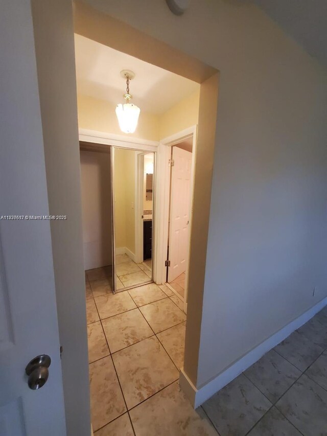 1450 NE 191st St Unit 106, Miami, FL 33179 - hall featuring baseboards and light tile patterned floors