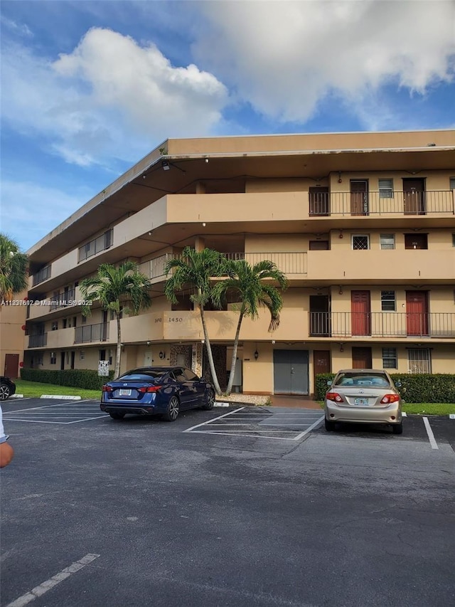 1450 NE 191st St Unit 106, Miami, FL 33179 - view of apartment building / complex featuring uncovered parking