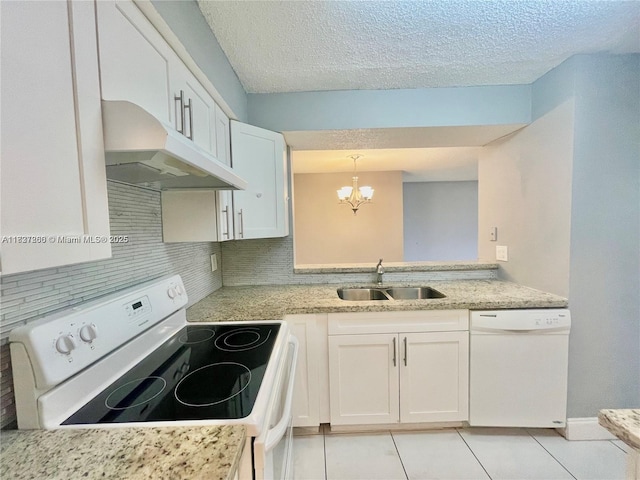 1231 SW 46th Ave Unit 507, Pompano Beach, FL 33069 - kitchen featuring white appliances, under cabinet range hood, a chandelier, decorative backsplash, and light tile patterned floors