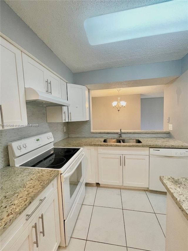 1231 SW 46th Ave Unit 507, Pompano Beach, FL 33069 - kitchen featuring white appliances, under cabinet range hood, a chandelier, light tile patterned floors, and white cabinetry