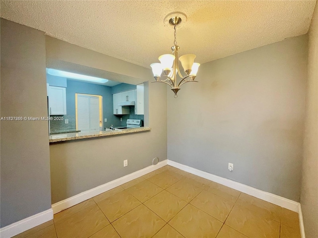 1231 SW 46th Ave Unit 507, Pompano Beach, FL 33069 - kitchen with white range with electric stovetop, a chandelier, tile patterned flooring, a textured ceiling, and pendant lighting