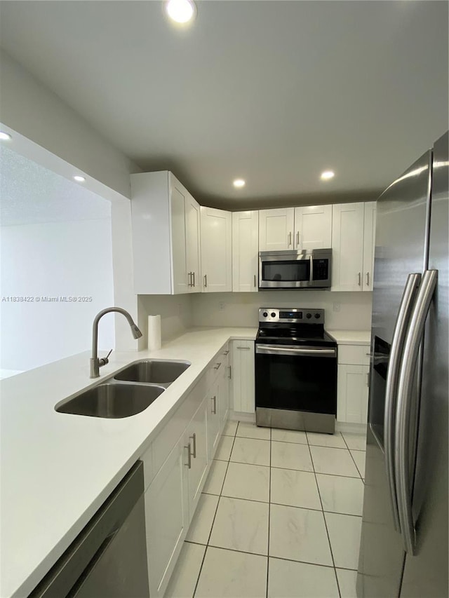 5705 W 20th Ave Unit 115, Hialeah, FL 33012 - kitchen with appliances with stainless steel finishes, white cabinets, light countertops, and recessed lighting