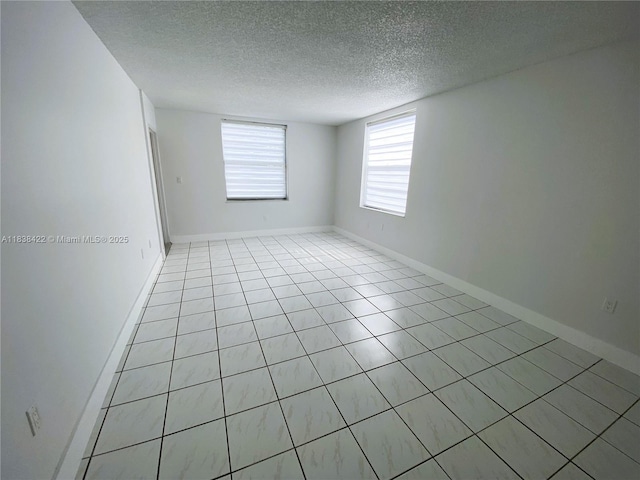 5705 W 20th Ave Unit 115, Hialeah, FL 33012 - empty room featuring a textured ceiling and light tile patterned floors