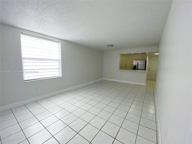 5705 W 20th Ave Unit 115, Hialeah, FL 33012 - spare room with a textured ceiling and light tile patterned flooring