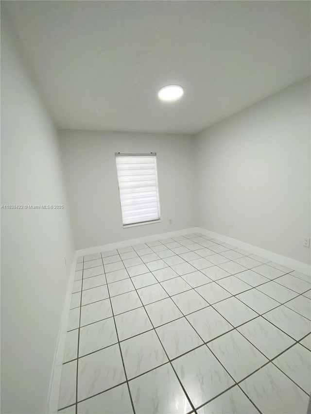 5705 W 20th Ave Unit 115, Hialeah, FL 33012 - unfurnished room with light tile patterned flooring and baseboards