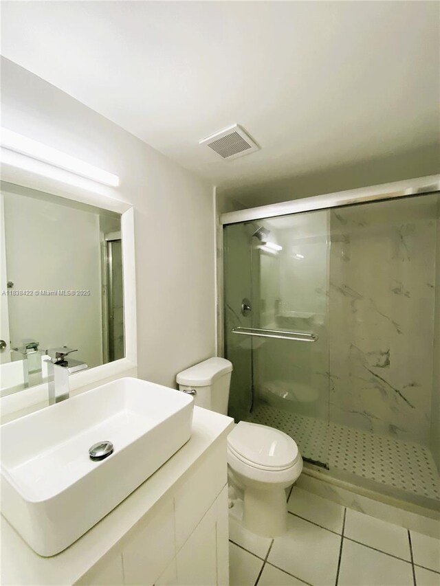 5705 W 20th Ave Unit 115, Hialeah, FL 33012 - bathroom with a marble finish shower, vanity, and tile patterned flooring