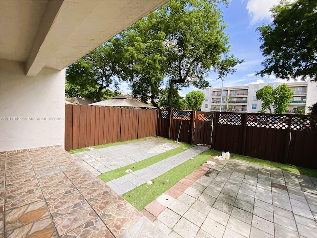 5705 W 20th Ave Unit 115, Hialeah, FL 33012 - fenced backyard with a patio