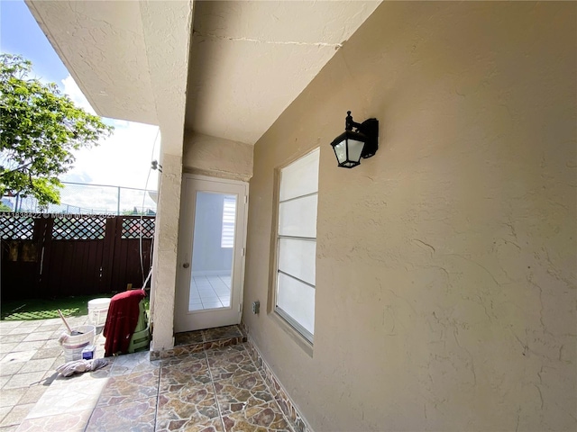 5705 W 20th Ave Unit 115, Hialeah, FL 33012 - doorway to outside featuring stone flooring and a textured wall