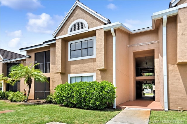 10670 SW 156th Pl Unit 304, Miami, FL 33196 - entrance to property featuring stucco siding and a yard