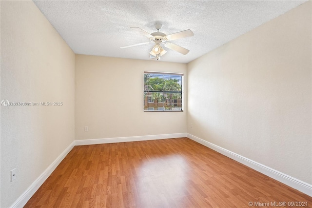 10670 SW 156th Pl Unit 304, Miami, FL 33196 - empty room featuring light wood finished floors, ceiling fan, and a textured ceiling