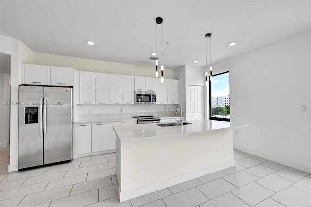 8167 NW 41st St Unit E-406, Doral, FL 33166 - kitchen with appliances with stainless steel finishes, light countertops, white cabinets, a kitchen island with sink, and light tile patterned floors