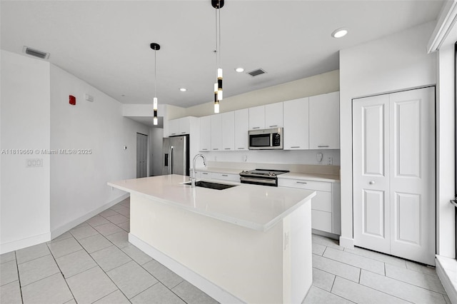 8167 NW 41st St Unit E-406, Doral, FL 33166 - kitchen featuring stainless steel appliances, light tile patterned flooring, white cabinetry, a center island with sink, and recessed lighting