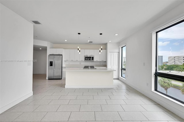 8167 NW 41st St Unit E-406, Doral, FL 33166 - kitchen with stainless steel appliances, white cabinets, light countertops, a kitchen island with sink, and recessed lighting