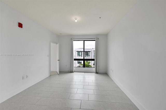 8167 NW 41st St Unit E-406, Doral, FL 33166 - empty room featuring baseboards and light tile patterned flooring