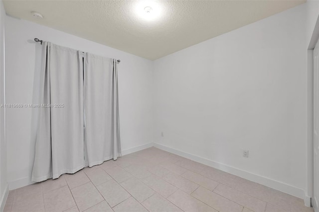8167 NW 41st St Unit E-406, Doral, FL 33166 - spare room featuring a textured ceiling and a smoke detector