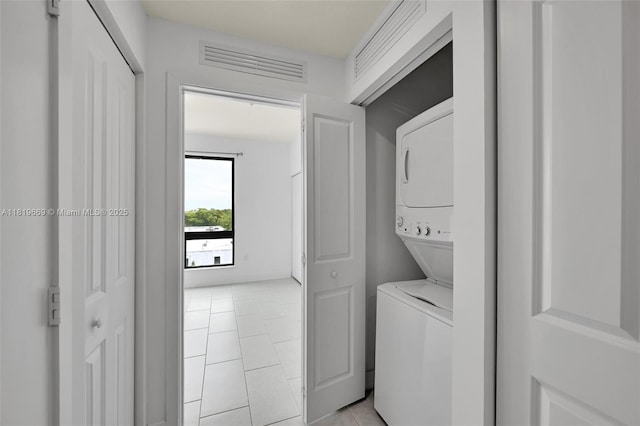 8167 NW 41st St Unit E-406, Doral, FL 33166 - laundry area featuring stacked washer / dryer and light tile patterned flooring