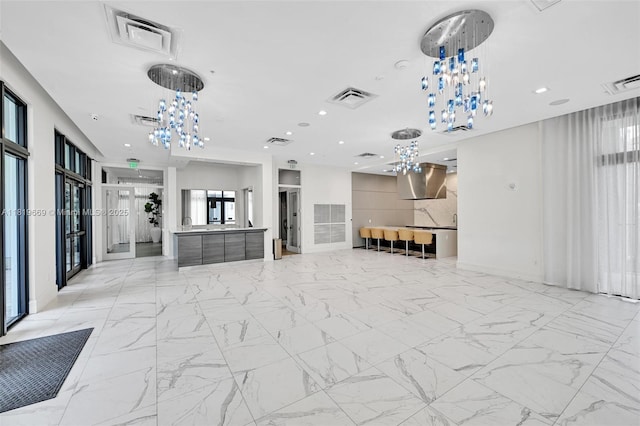 8167 NW 41st St Unit E-406, Doral, FL 33166 - unfurnished living room featuring a chandelier and recessed lighting