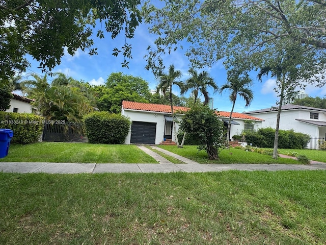 141 SW 20th Rd, Miami, FL 33129 - ranch-style house with an attached garage, a tiled roof, stucco siding, and driveway