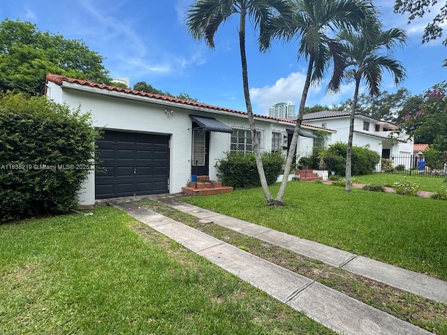 141 SW 20th Rd, Miami, FL 33129 - view of front of property featuring stucco siding, driveway, a garage, and a tiled roof
