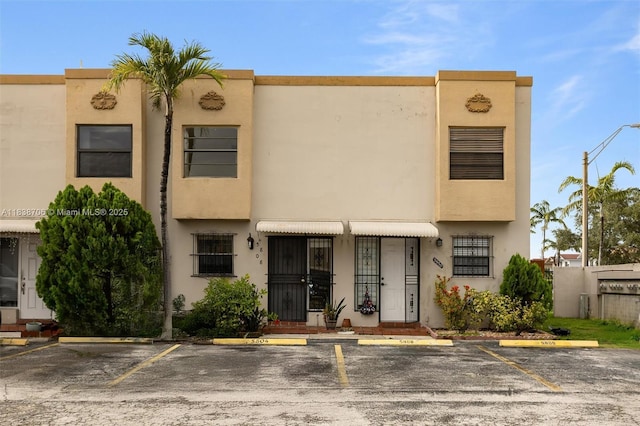 5808 W 26th Ave Unit 211, Hialeah, FL 33016 - view of front facade with uncovered parking and stucco siding