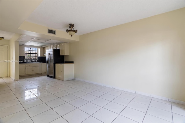 5808 W 26th Ave Unit 211, Hialeah, FL 33016 - kitchen with stainless steel refrigerator with ice dispenser, light tile patterned floors, and dark countertops