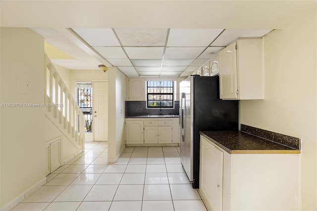5808 W 26th Ave Unit 211, Hialeah, FL 33016 - kitchen with dark countertops, stainless steel fridge, healthy amount of natural light, and light tile patterned floors