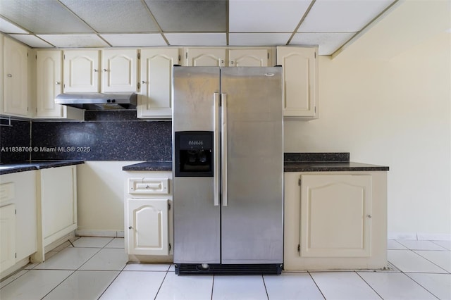 5808 W 26th Ave Unit 211, Hialeah, FL 33016 - kitchen featuring stainless steel fridge with ice dispenser, under cabinet range hood, dark countertops, a drop ceiling, and decorative backsplash